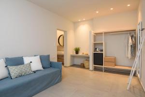 a living room with a blue couch and a closet at Vigla Hotel in Aegiali