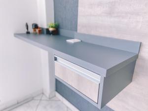 a counter in a bathroom with a blue counter top at Nacional Park Hotel Lages in Lages