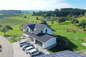 an aerial view of a house with solar panels at Haus am See - Ferienwohnungen in Neukirch