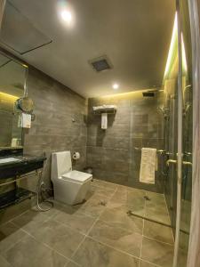 a bathroom with a toilet and a shower at Le Levels Residency in Dammam