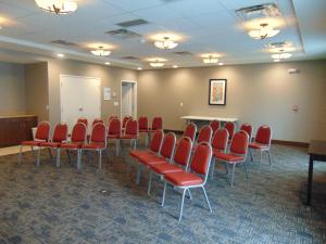 einen Konferenzraum mit roten Stühlen und einem Tisch in der Unterkunft Holiday Inn Express & Suites Springville-South Provo Area, an IHG Hotel in Springville