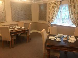 a dining room with a table and chairs and a window at The White Pheasant in Lenwade