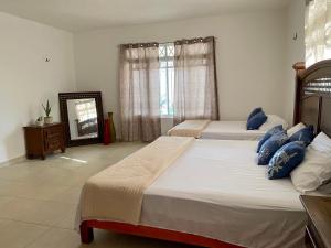 מיטה או מיטות בחדר ב-Casa Pescador Bacalar