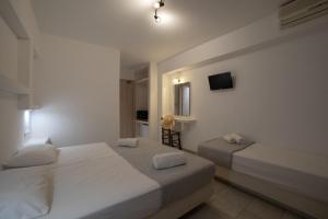 Tempat tidur dalam kamar di Aphrodite Hotel & Apartments