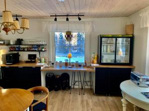 a kitchen with a table and a large window at Villa Bergli in Malung