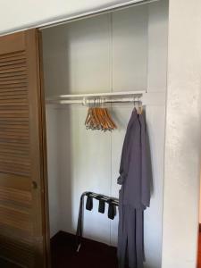 
a person standing in a room next to a closet at Villa Rosa Inn in Santa Barbara
