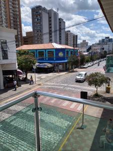 a view of a city street with a blue building at Hotel Alzira Imperial in São Lourenço