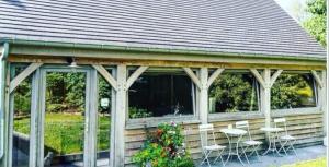 a gazebo with chairs and tables on it at De linderd in Aalst