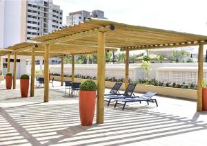a patio with chairs and a pavilion with benches at ALTA VISTA THERMAS RESORT in Caldas Novas