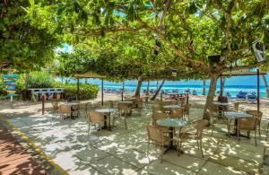 a group of tables and chairs on the beach at Coconut Court Beach Hotel in Bridgetown