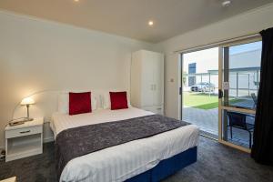 
a hotel room with a bed and a window at The White Morph - Heritage Collection in Kaikoura
