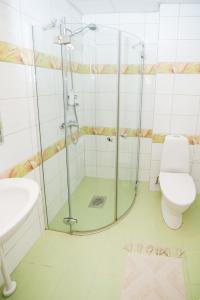 a bathroom with a shower and a toilet and a sink at Küüni 5b Guest Apartment in Tartu