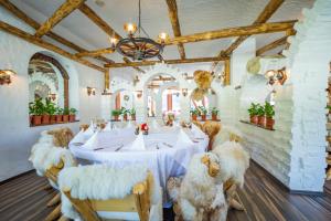 a dining room with a table with furry chairs at Vila Miorita in Poiana Brasov +80 photos