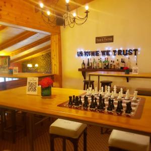 a chess board on a table in a bar at Kalken Hotel by MH in El Calafate