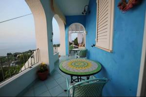 a balcony with a table and chairs on a balcony at Belvedere in Castro di Lecce