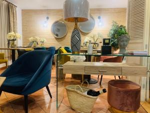 a room with a table and a chair and a table with a bust at Alda Casa De Los Reyes in Toledo