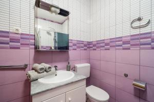 a pink bathroom with a sink and a mirror at Apartments Zrno in Cavtat +46 photos