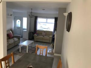 a living room with a table and a couch at Diana House - Great location in Coventry