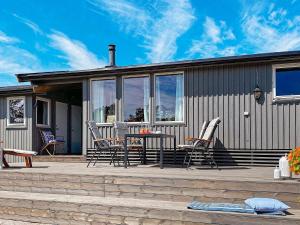 a patio with chairs and a table on a house at 9 person holiday home in Vester y in Hauge