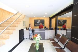 a woman standing at the counter of a hair salon at Hotel Plaza Muisca in Tunja