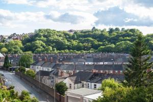 a town with houses and trees on a hill at Brynglas Newport flat sleeps 8 - Mycityhaven in Newport