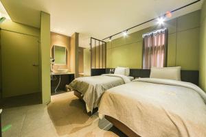 Un ou plusieurs lits dans un hébergement de l'établissement Hotel Myeongjak