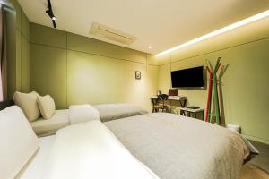 Un ou plusieurs lits dans un hébergement de l'établissement Hotel Myeongjak