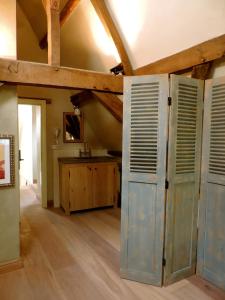 an old barn door in a room with a table at B&B Saint-Sauveur Bruges in Bruges