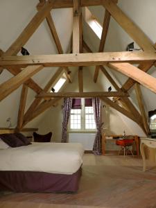 a bedroom with a bed in a attic at B&B Saint-Sauveur Bruges in Bruges