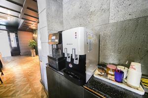 a coffee machine sitting on a counter in a kitchen at Hotel Myeongjak in Chuncheon