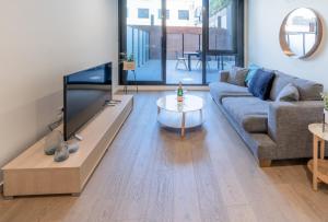 a living room with a large flat screen tv at Melbourne City Apartments - Teri in Melbourne