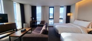 Postel nebo postele na pokoji v ubytování Ramada Encore by Wyndham Busan Haeundae