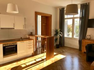 a kitchen with a table in the middle of a room at Dein Gutshof Hotel & Ferienwohnungen in Görlitz