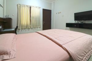Postel nebo postele na pokoji v ubytování Bendungan Hilir Residence