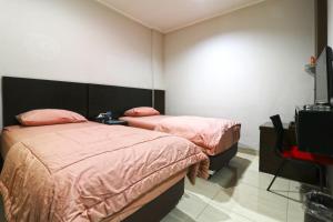 Postel nebo postele na pokoji v ubytování Bendungan Hilir Residence
