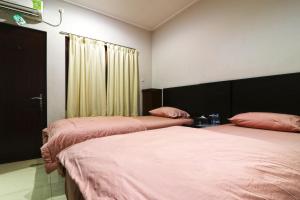 Postel nebo postele na pokoji v ubytování Bendungan Hilir Residence