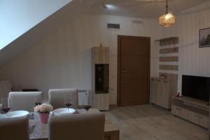 a living room with a table and chairs and a door at Kraljev Konak in Kopaonik