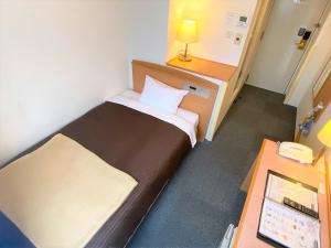 Postel nebo postele na pokoji v ubytování Sakura Hotel Hatagaya