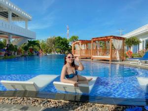 a woman in a bikini sitting in a pool at Fairy Hills Hotel in Mui Ne