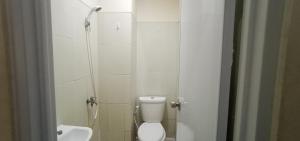 a small bathroom with a toilet and a sink at Giant Kost in Tangerang