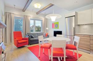 a kitchen and living room with a table and chairs at Holiday Club Saariselkä Superior Apartments in Saariselka