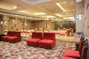 a conference room with red chairs and a table at Citrus Prime Raipur in Raipur