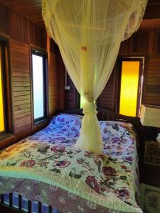 Säng eller sängar i ett rum på Ban Suan Khun Yai
