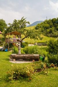 a garden with a playground in the middle of a field at Ferienhaus Hallweger inkl. Chiemgaukarte in Ruhpolding +2 photos