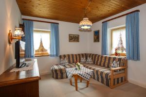 a living room with a couch and a table at Ferienhaus Hallweger in Ruhpolding