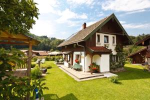 a house with a green yard with a house at Ferienhaus Hallweger in Ruhpolding