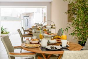a table with breakfast food on top of it at Balance Hotel in Chania Town
