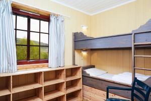a bedroom with bunk beds and a window at Brennabu in Ron