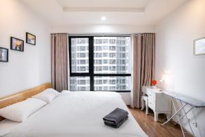 a bedroom with a white bed and a large window at BOM HOMES- VINHOMES TIMES CITY- 2BR-LUXURY APt in Hanoi +55 photos