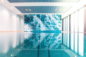 a room with a glacier mural on the wall at City Hotel Roding in Roding